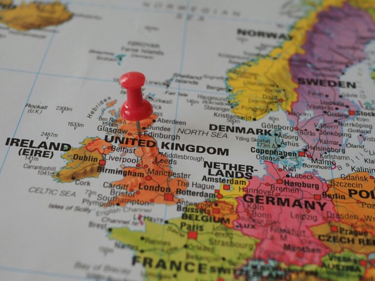 Red pushpin marking the United Kingdom on a map of Europe, highlighting nearby countries like Ireland, France, and Germany.